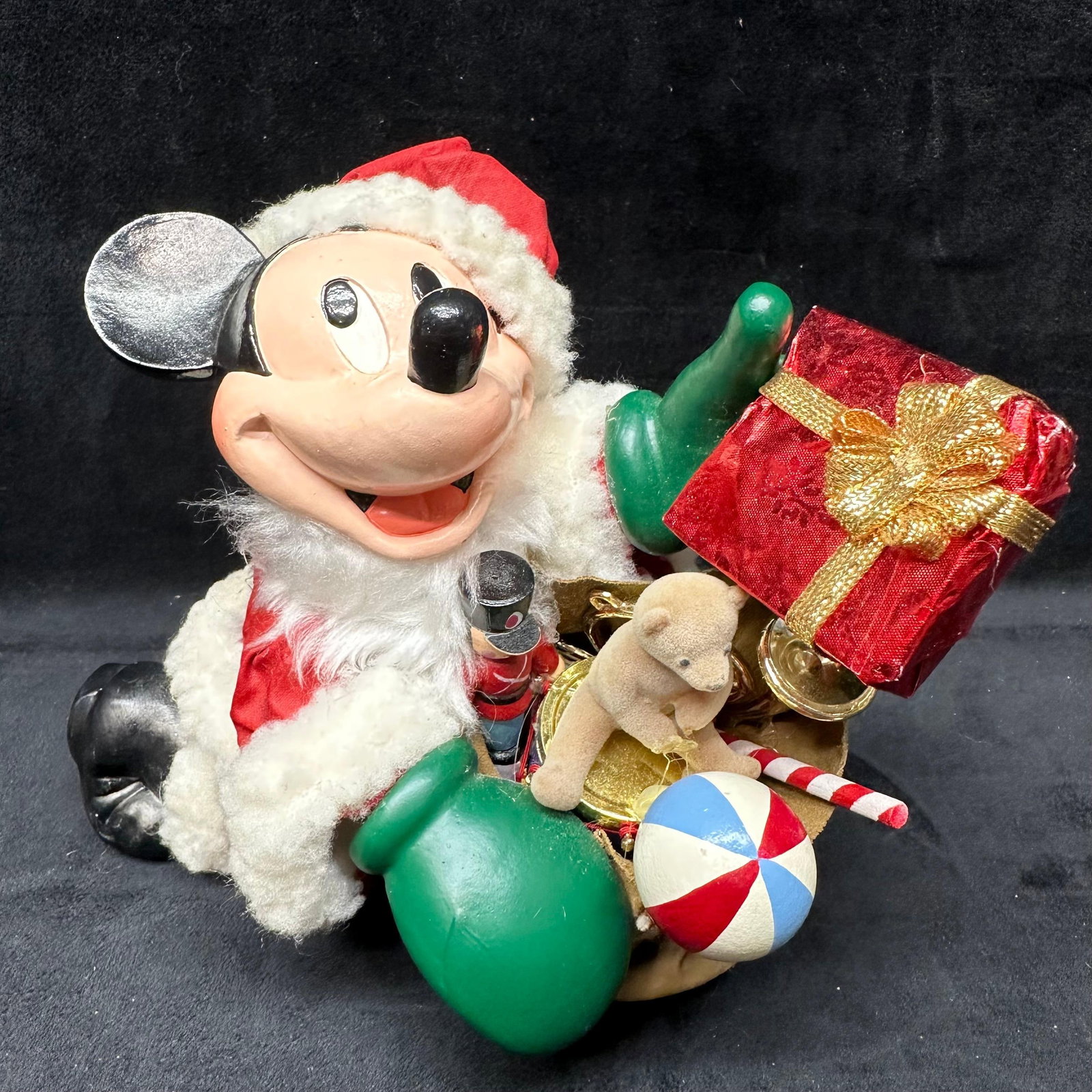 Disney Santa Mickey Mouse Christmas Holiday Figure Decor: Disney Santa Mickey Mouse holiday figure featuring Mickey dressed in a Santa suit with faux fur trim, holding a present, and a toy-filled gift bag. Mixed materials: resin, fabric, faux fur, and plasti