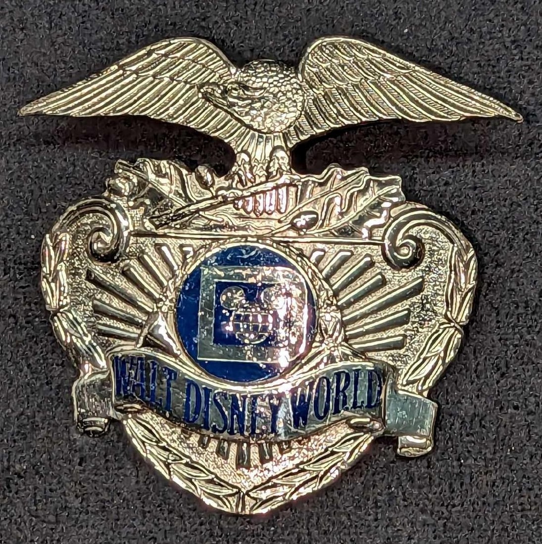 1980s Disney World Security Hat Metal Badge 1026: 1980s Disney World Security Hat Metal Badge 1026. Is approx 2 3/4" x 1" x 2 3/4" and it weighs under one pound at 0.11lb. The metal badge is in a good, vintage condition with some wea