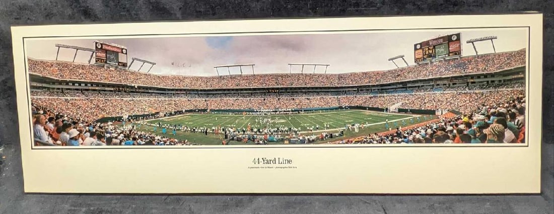 Robert Arra 44-Yard Line Miami Dolphins Stadium Print On Wood: Robert Arra 44-Yard Line Miami Dolphins Stadium Print On Wood. This is a framed print on a particular board. This is approx 39 1/2" 1" x 13 1/4" and it weighs 4.30lbs. This is an olde