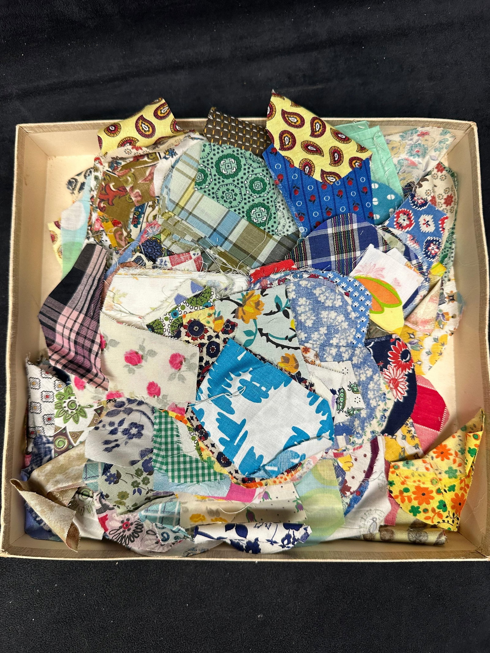 Vintage Quilt Fabric Scrap Lot With Roland Lexington Box: An assorted lot of vintage fabric scraps, including various patterns and pre-cut quilt pieces. Includes circular template and additional square fabric pieces. Housed in the original Roland of