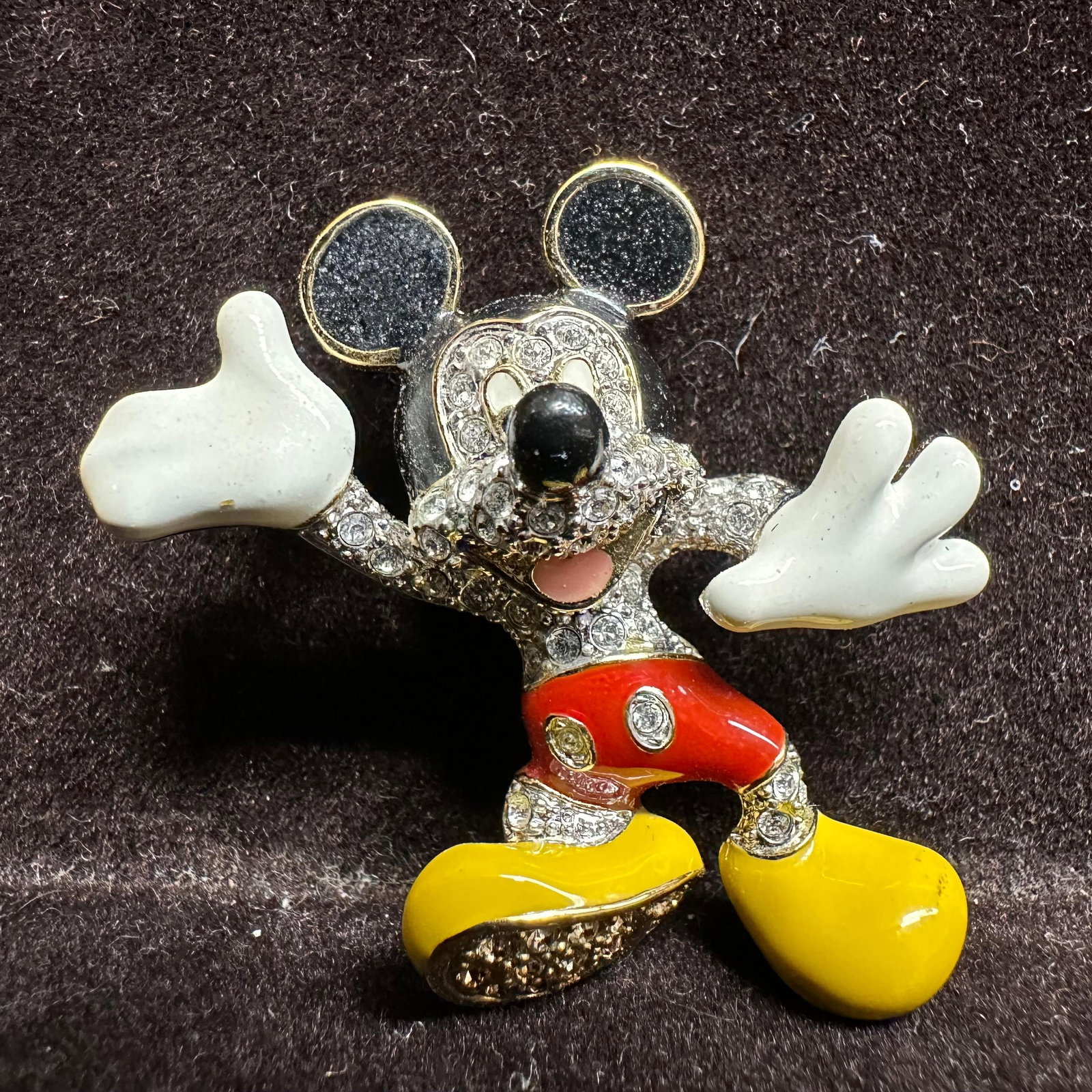 Disney Arribas Brothers Pave Set Clear Crystal Rhinestone Mickey Mouse Brooch: Hallmark Arribas Brothers on the back of the gold-toned brooch. Gold-tone Disney Parks brooch by Arribas Brothers featuring Mickey Mouse. Set with clear rhinestones and accented with black, red, yello