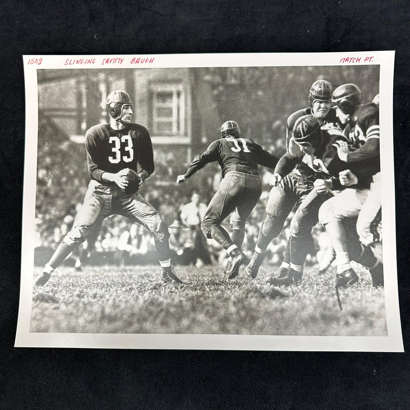 1940's Football Silver Gelatin Print Slingin Sammy Baugh Action Shot: Black-and-white analog photo print depicting Hall of Fame quarterback “Slingin’” Sammy Baugh (#33) mid-play, surrounded by teammates and defenders during a classic 1940s NFL game. Ha