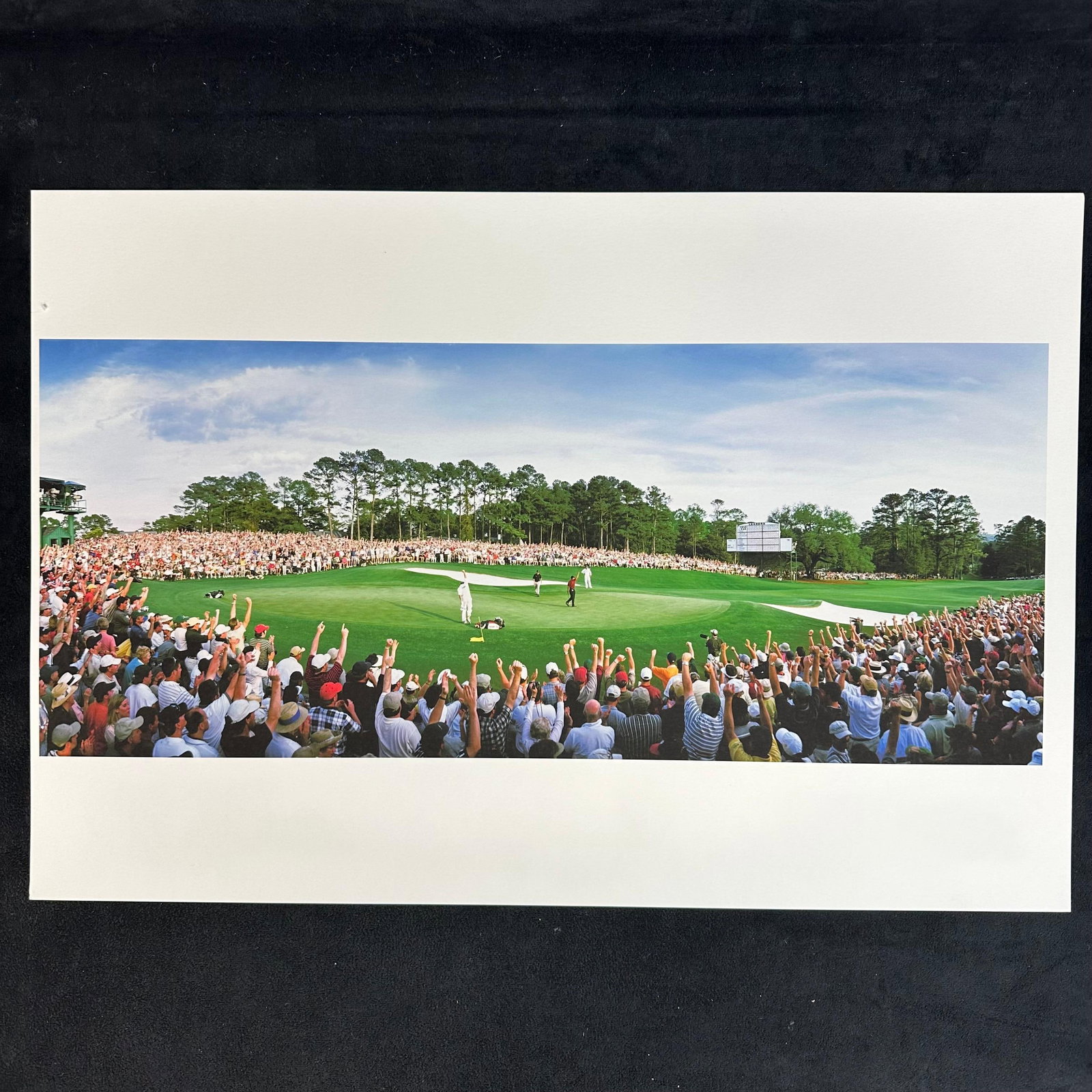 Tiger Woods Masters Victory Celebration Golf Crowd Photograph High-Quality Print: A panoramic color photograph captures the electrifying moment of Tiger Woods’ Masters victory, as fans erupt in celebration around the 18th green at Augusta National. Professionally printed on h