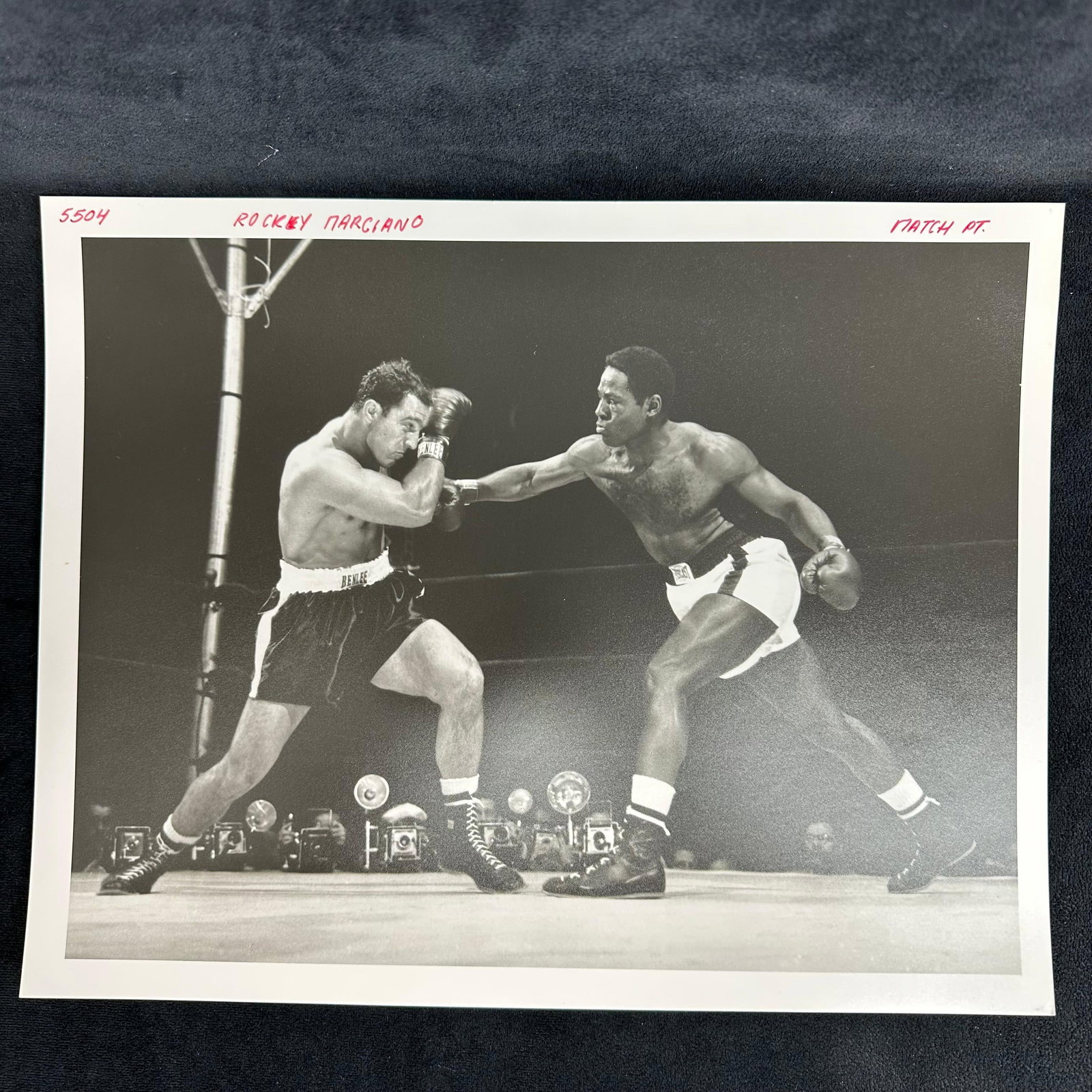 Rocky Marciano and Ezzard Charles Analog Black and White Photograph Print Boxing Photo: Black and white analog photograph print capturing the legendary heavyweight bout between Rocky Marciano and Ezzard Charles. Printed on pearl resin-coated photo paper with red ink notations at the top 