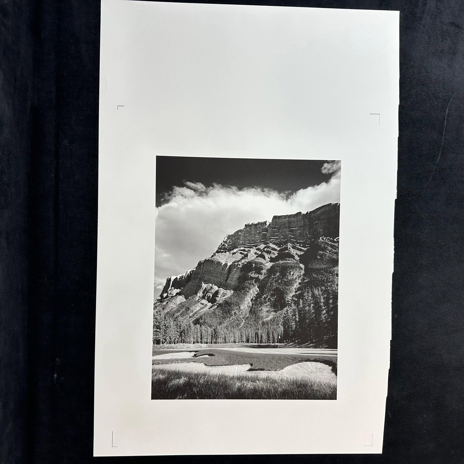 Black and White Fine Art Landscape Photo Print Mountain Scene with Cloudscape Overlook Golf Course: Black and white fine art photograph print depicting a dramatic mountain range under a textured sky with scattered clouds. The image captures layered rock formations and a sweeping valley foreground, o