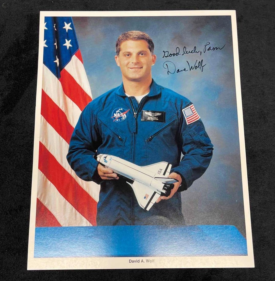 Signed & Inscribed Vintage Photograph Of Astronaut David A. Wolf (JBH25): This lot contains a Signed & Inscribed Photograph Of Astronaut David A. Wolf (JBH25). The Photograph is signed and inscribed in black felt tip marker as "Good Luck, Pam Dave Wolf" in the