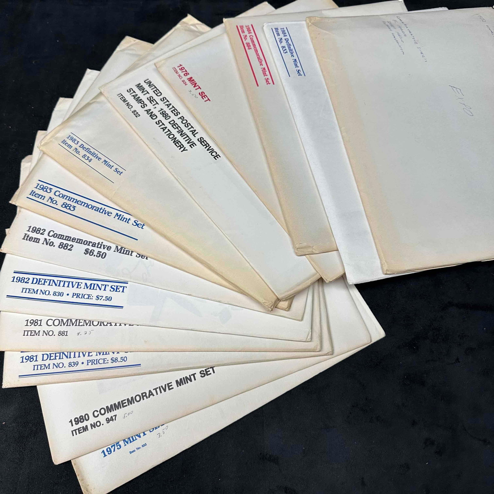 Mixed Lot US Commemorative Stamps Mint Set: Each set includes US Stamps, booklets, and other collector pieces. Thirteen sets included from the late 70's to 1980's. These items are in good pre-owned, previously displayed condition with l