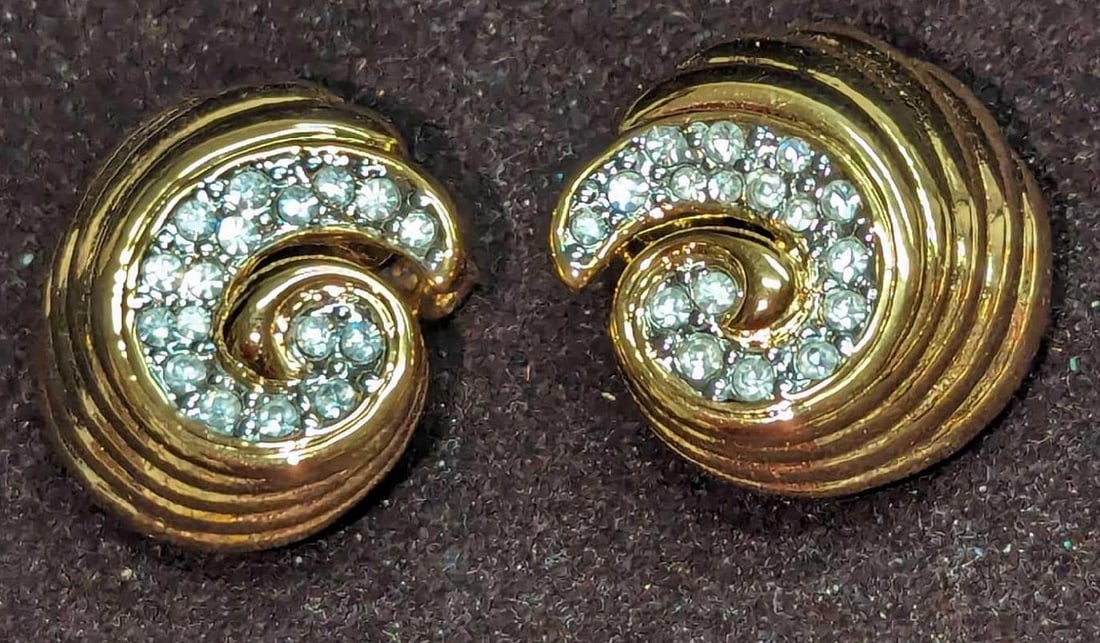 Nolan Miller Gold Domed Rhinestone Swirl Clip Earrings: Nolan Miller Gold Domed Rhinestone Swirl Clip Earrings. Each gold-plated earring is approx 1" x 1/2" x 1". It comes in a bag that is 3" x 3/8" x 3 1/4" and it weighs 0.06lb. 