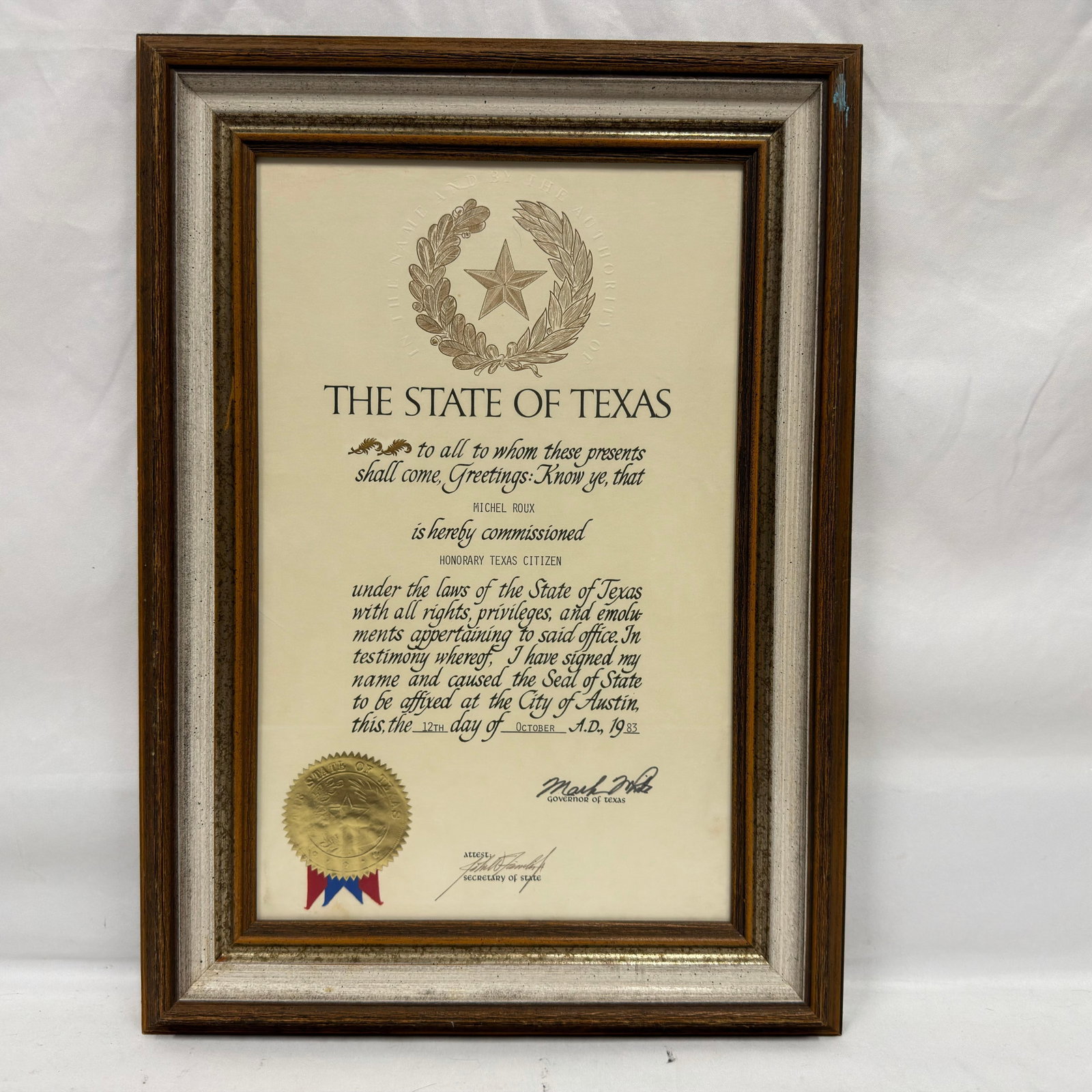 Michel Roux Honorary Texas Citizen Commission: Framed State of Texas honorary commission presented to Michel Roux, naming him an Honorary Texas Citizen. Issued at Austin on October 12, 1983, during the administration of Governor Mark White, with