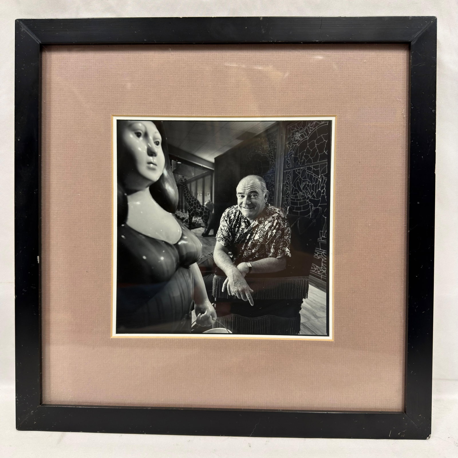 Framed Black and White Photograph of Michel Roux French Liquor Executive: Framed black-and-white portrait photograph of Michel Roux, presented alongside a sculptural figure. Matted under glass in a black frame. Pre-owned, previously displayed condition with light wear,
