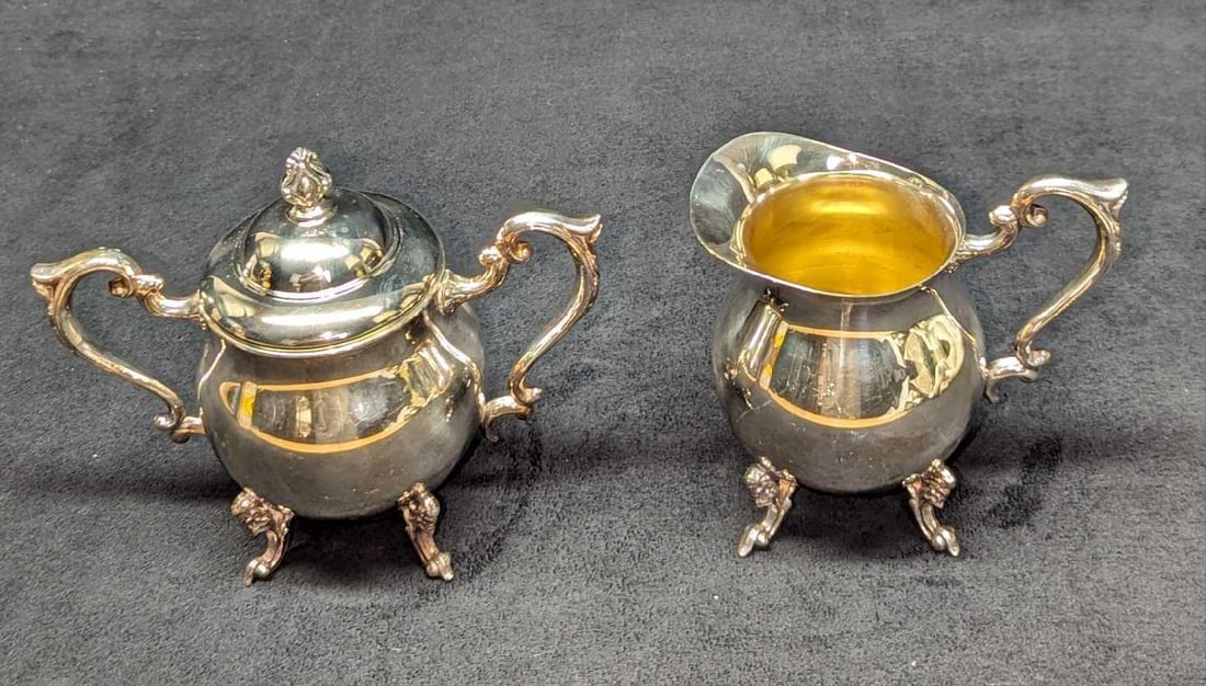 Vintage Sheridan Silver On Copper Sugar Bowl & Creamer: Vintage Sheridan Silver On Copper Sugar Bowl & Creamer. The creamer is approx 5" x 3 1/2" x 5" and it weighs 0.78lb. The sugar bowl is approx 7" x 4" x 6" and it weighs 1.06lb. There are some light sc