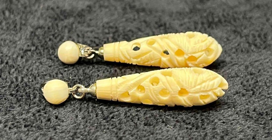 Hand Carved Bone Dangle Earrings: This lot contains a Hand Carved Bone Dangle Earrings. Each earring is approx 1 3/4" x 1/4" x 1/4". Total weight is approx less than 1 gram. Overall the Hand Carved Bone Dangle Earrings are in excellen