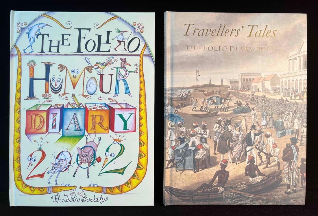 Two Folio Society Diaries 2001 Travelers Tales & 2002 Humor Diary: This lot contains Two Folio Society Diaries 2001 Travelers Tales & 2002 Humor Diary. Each book is approx 7 3/4" x 5 3/4" and the total weight is approx 1.3lbs. Overall the books are in good used 