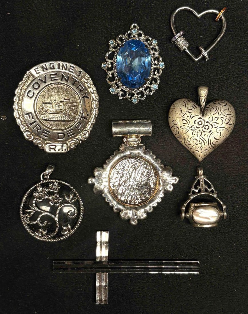8pc Silvertone Charms and Pendants Collection: This lot contains 8 pieces of pre-owned costume jewelry pendants. Each piece is in good condition, with wear and tear over the years visible on some of the jewelry. Please review images for context