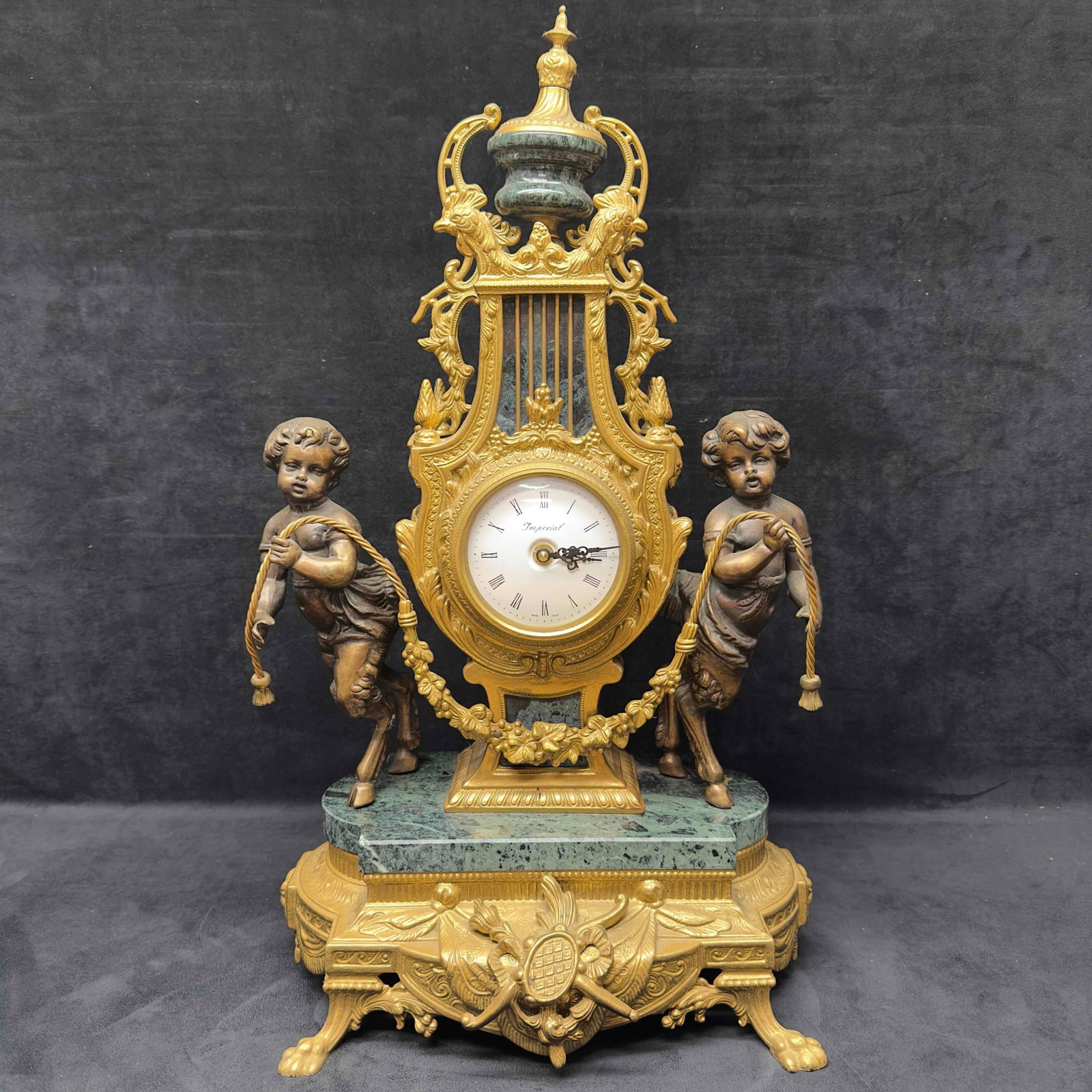 Franz Hermle Imperial Italian Mantle Clock Marble and Brass Cherub Angel Mid 20th Century Style R119: Franz Hermle Imperial Italian Mantle Clock Marble and Brass Mid 20th Century Style R119. Minor imperfections with one cherub loose disconnected on the clock, needs repair. Has Not Been Tested, Sold