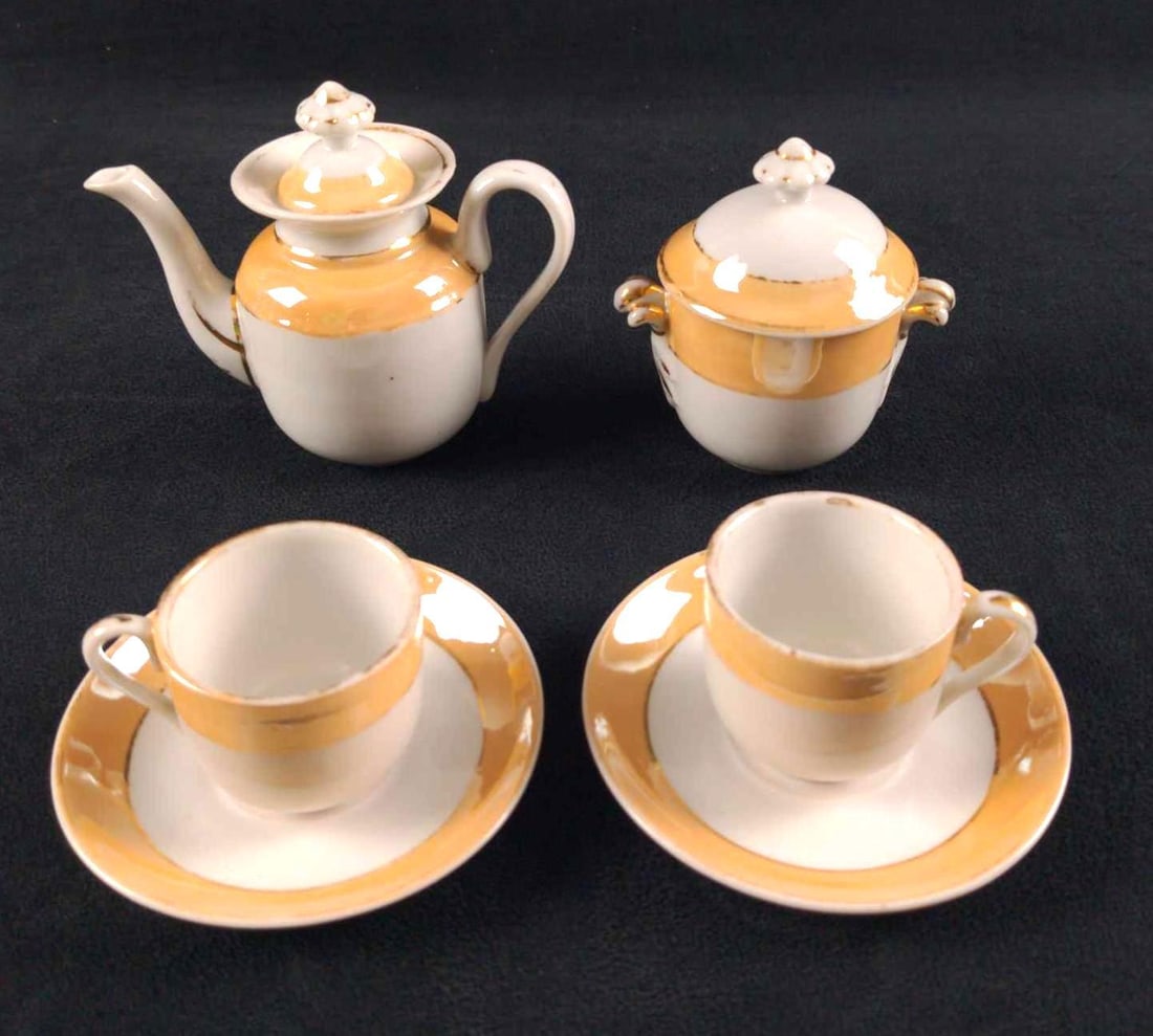 Vintage Lusterware Minature Porcelain Tea Set: This lot includes: (6) Saucers. These are approx 4" x 4". (4) Demitasse Tea Cups. These are approx 2 1/2" x 2" x 2". (1) Tea Pot. This is approx 5" x 2" x 4". (1) Sugar
