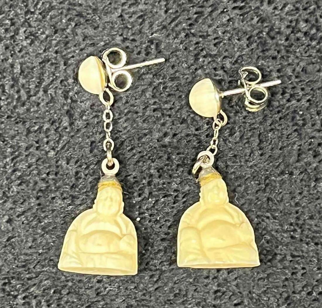 Hand Carved Bone Buddha Dangle Earrings: This lot contains Hand Carved Bone Buddha Dangle Earrings. Each earring is approx 1 1/4" x 1/2" x 1/4". Total weight is approx less than 1 gram. Overall the Hand Carved Bone Buddha Dangle Earrings