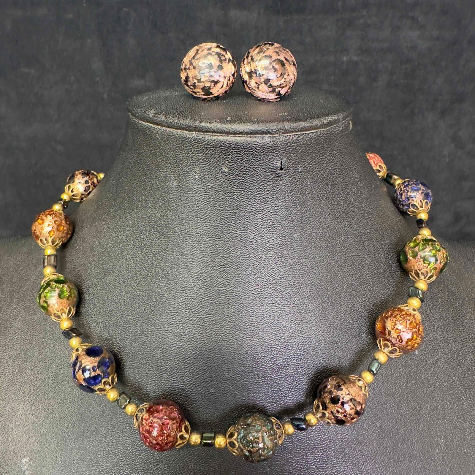 Murano Venetian Lamp Work Glass Dark Colored Round Bead Necklace and Copper Accent Earrings Set A41: Murano Venetian Lamp Work Glass Dark Colored Round Bead Necklace and Copper Accent Earrings Set A41. Necklace and earrings with dark colored glass beads with beautiful designs on each. The neckla