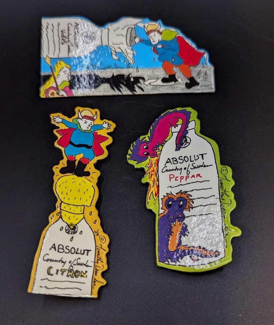 3 Absolut Vodka Peppar Advertising Art Pins / Brooches B: 3 Absolut Vodka Peppar Advertising Art Pins / Brooches B. By Timothy Dean Lee. Each is made of a Laminated Art Board. This was released from the year 1990 to the year 1991. The set is approx 1 5/8"x