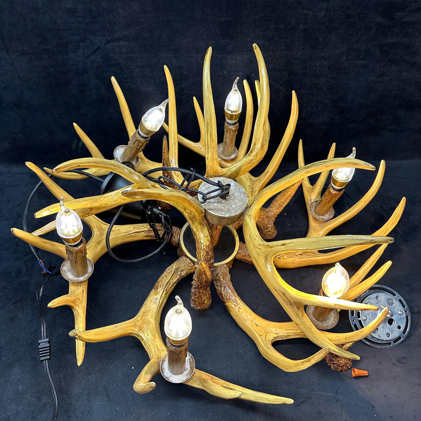 Rustic Antler Form Six Light Chandelier Fixture Hunter Style: Rustic antler form six light chandelier with faux deer antler construction and wood tone candle style sockets. Fixture features a hanging chain and a ceiling mount canopy. Tested and lights illuminate