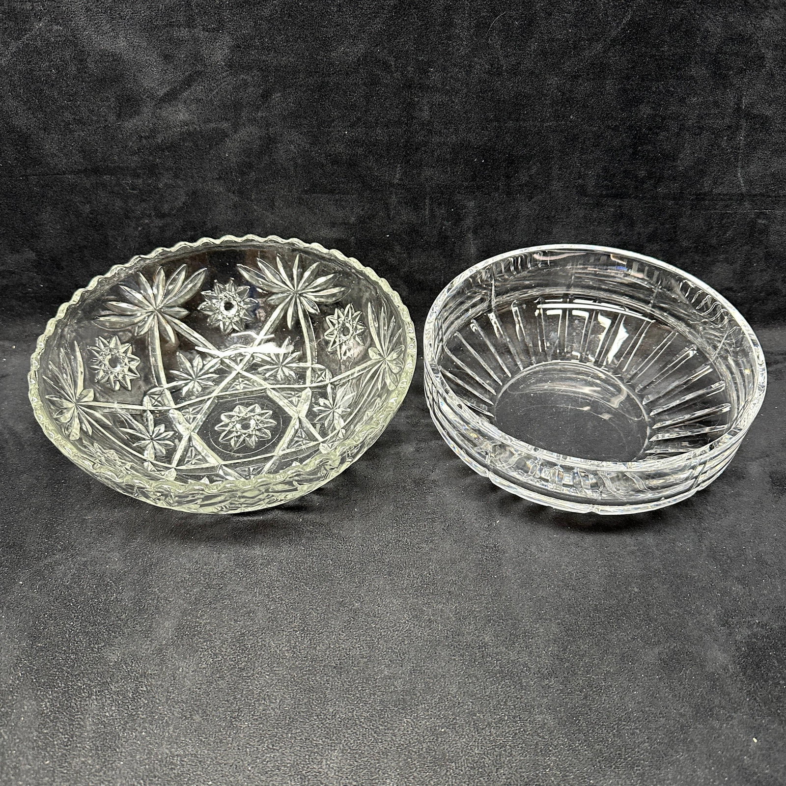 Two Vintage Cut Glass Serving Bowls: Pair of vintage clear glass serving bowls including one pressed glass bowl with starburst and geometric decoration and one heavier cut glass bowl with vertical panel cuts. Light surface wear consisten