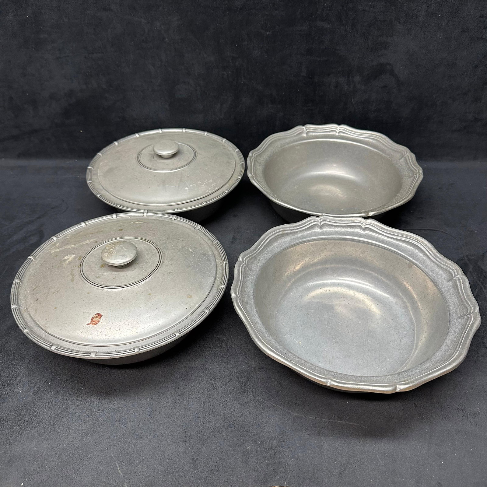 Pair of Wilton Armetale Pewter Covered Serving Bowls Dishes: Set of two matching Wilton Armetale pewter-covered serving bowls, each marked 1974 Wilton, Columbia, PA, USA. These heavy alloy bowls feature classic Colonial and scalloped edge designs, ideal for tab