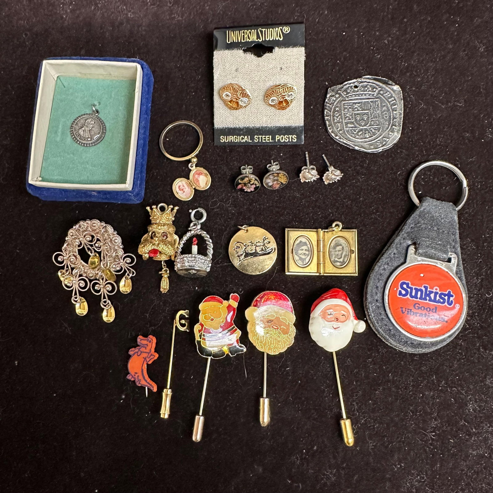 Assorted Jewelry and Collectibles Mixed Lot Charms Pins Lockets Earrings Stick Pins and Keychain: An assortment of vintage and novelty jewelry, along with collectible pieces, featuring a fun mix of eras and styles. Includes Christmas Santa stick pins, Sunkist “Good Vibrations” key chai