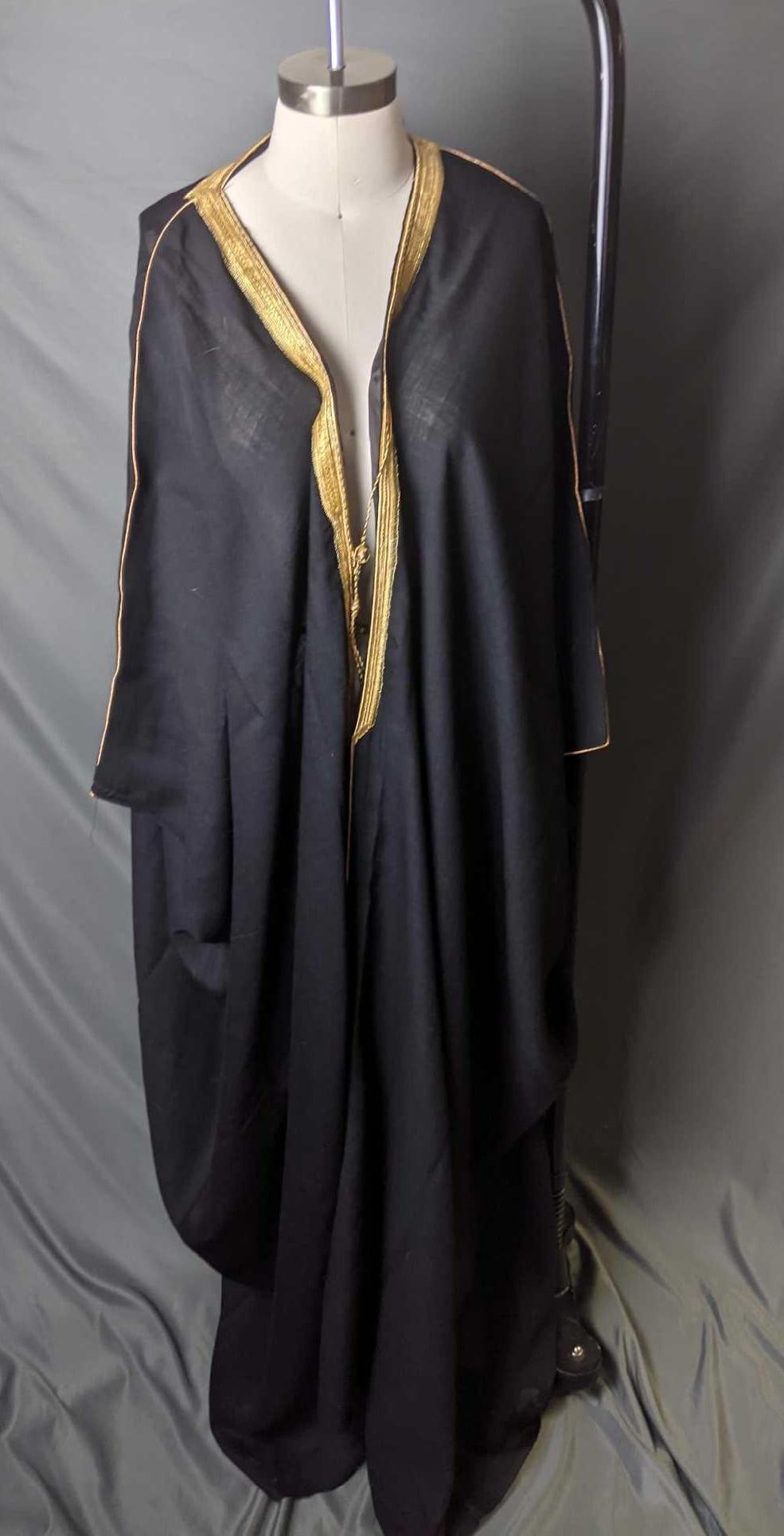 Arab Bisht Black and Gold Bisht From Saudi Arabia: Arab Bisht Black and Gold Bisht From Saudi Arabia This is called a Bisht aka mishlaḥ or abā, it is in good condition but has a few tiny holes. It was made in Saudi