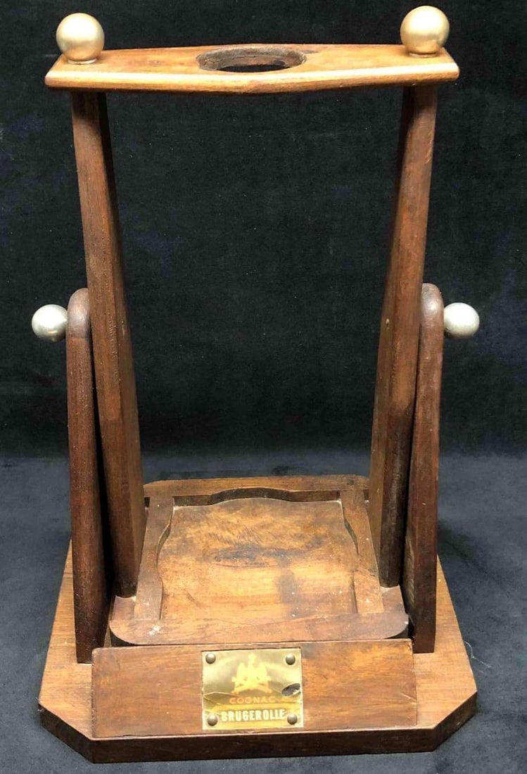 Vintage Wooden Cognac Brugerolle Cradle & Pouring Stand: This lot contains a wooden vintage Cognac Brugerolle Cradle & Pouring Stand.Perfect addition to any at home bar. It is approx 11" x 7" x 16 1/2" and weighs about 4.5lbs. The stand is in good vint