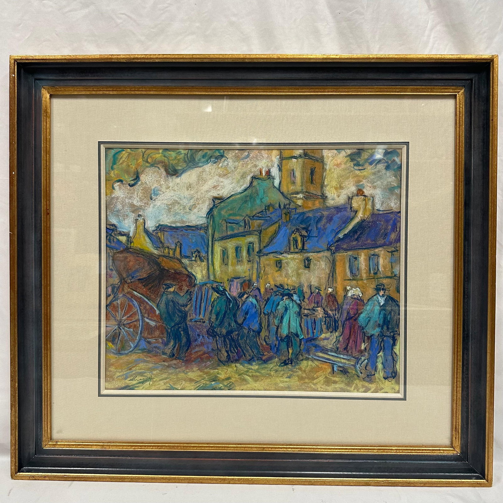Town Market Scene Pastel Painting Artist Signed Framed: Framed pastel or mixed-media artwork depicting a bustling town market scene with figures gathered along a street lined with old village buildings. Rich blues, yellows, and earth tones create a lively 