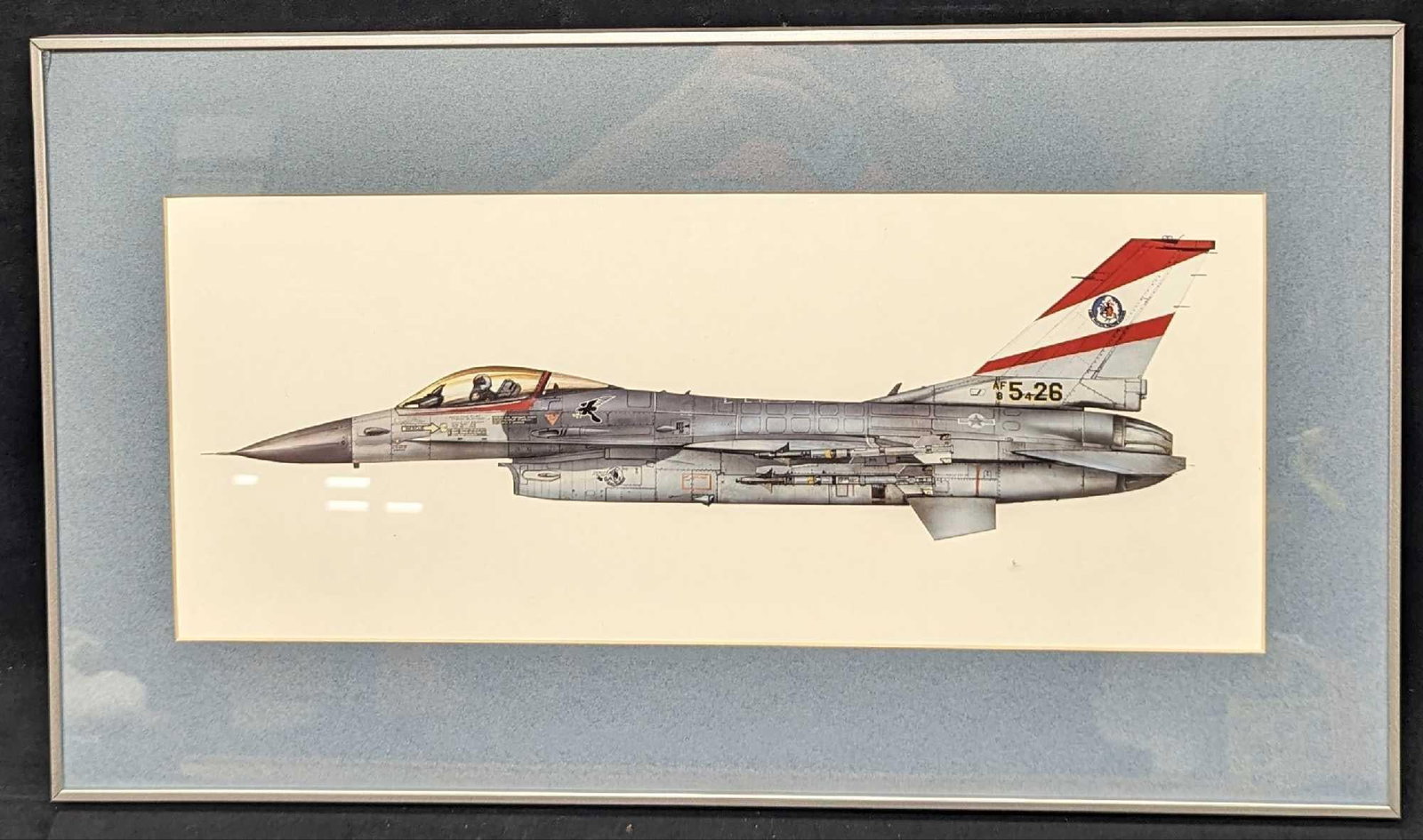 Framed F-16C Fighting Falcon Fighter Aircraft Print: Framed F-16C Fighting Falcon Fighter Aircraft Print. This framed print is approx 21 1/4" x 1" x 12 1/4' and it weighs 3.20 lbs. The print was not signed by the artist. There is a small