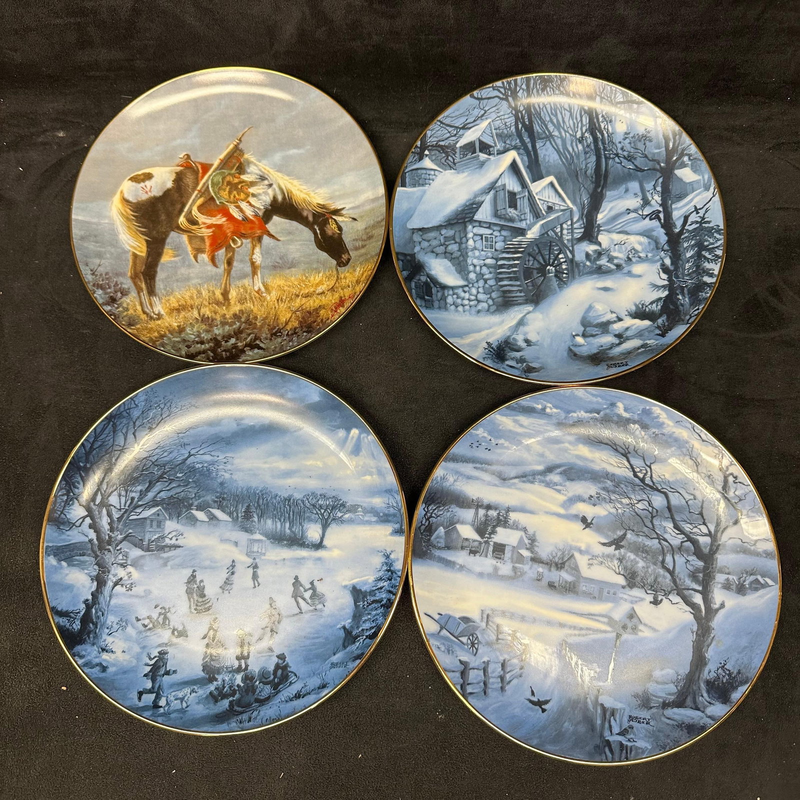 ArtAffects Collector Plates Four Collectible Plate Set of Four: Group of four decorative collector plates featuring a horse and winter scenes by various artists. Plates display seasonal imagery, including snow-covered villages, a horse, and cottage scenes. Marked 