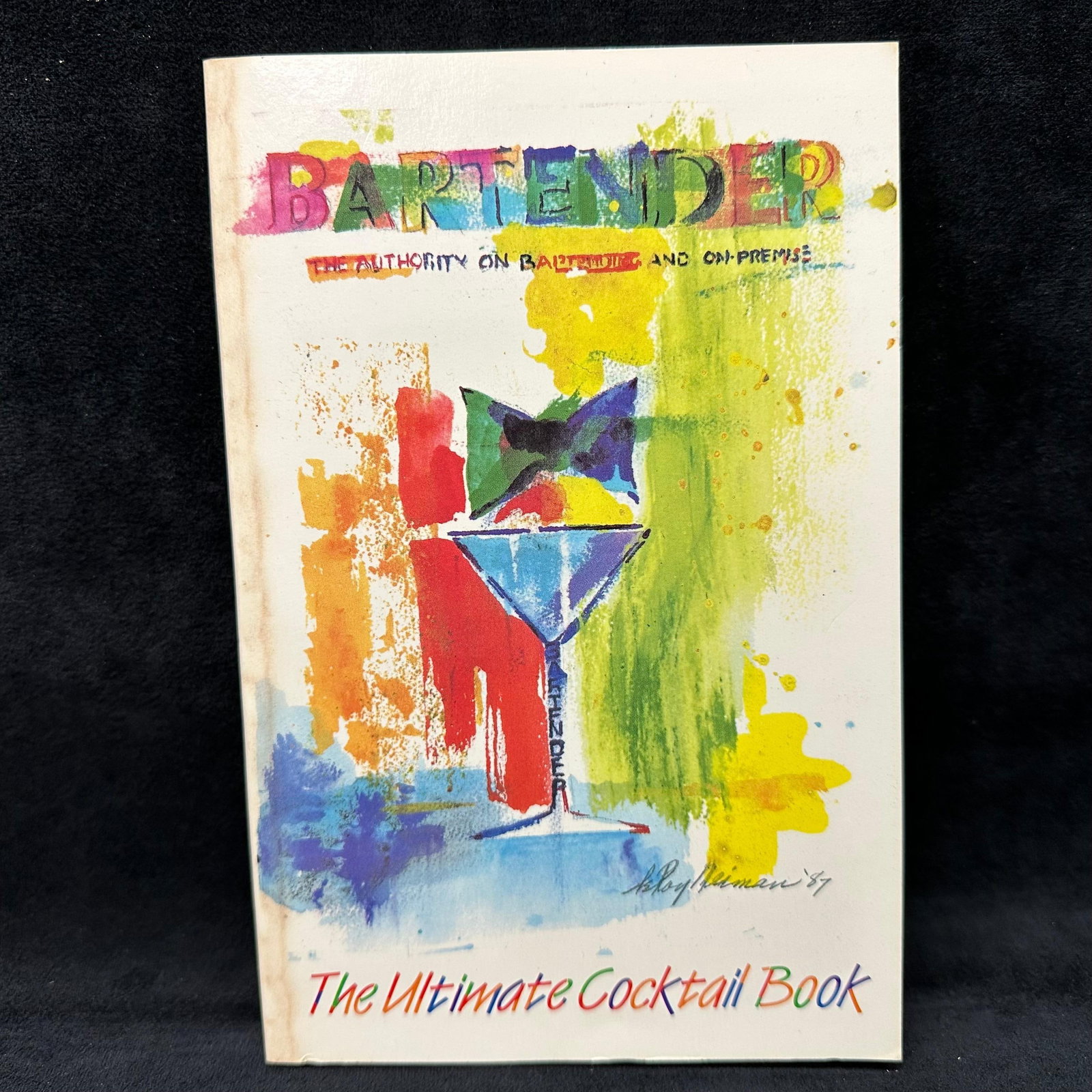 Signed Bartender The Ultimate Cocktail Book Softcover Raymond Foley: Signed with a personal inscription to Michel Roux. Condition shows general handling wear, scuffing, and surface marks to the cover consistent with age. Interior pages appear intact. Includes dust jack