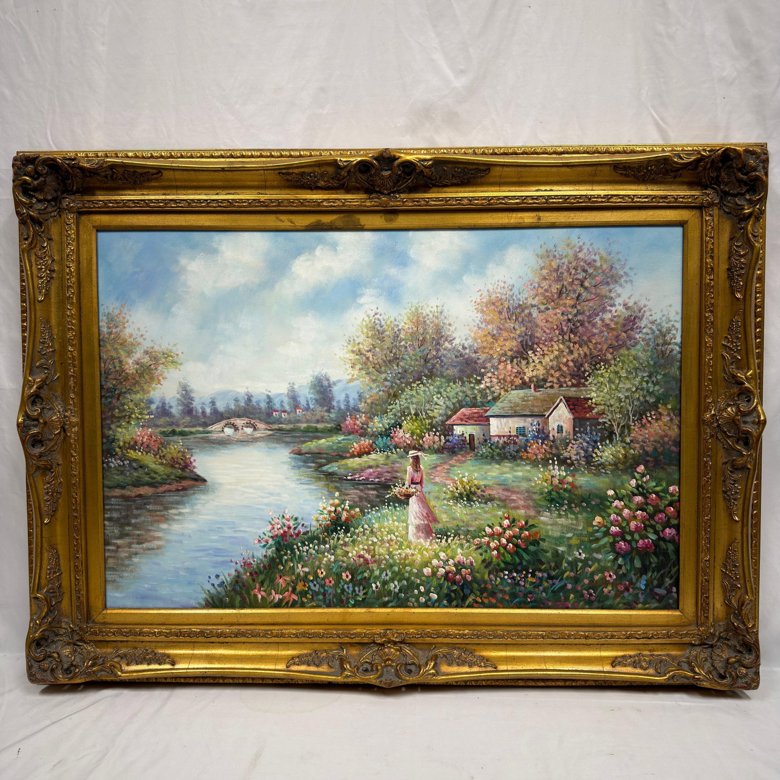 W Hodges Signed Floral Riverside Landscape Painting on Canvas Large Frame: Original painting on canvas, signed W. Hodges lower right. The romantic garden landscape depicts a woman carrying flowers beside a calm river, surrounded by colorful flowering plants, cottages,