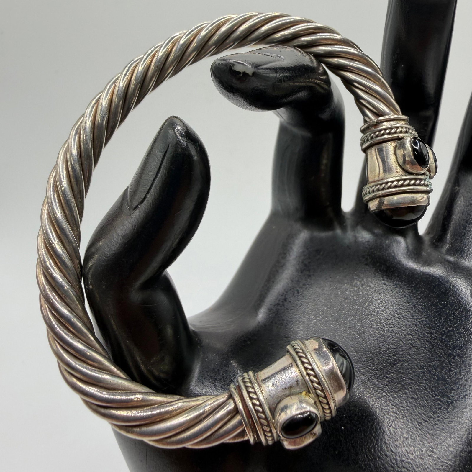 Renaissance Style Twist Cable Design Black Onyx Accent Terminal Sterling Silver Bangle Bracelet: This item is in pre-owned, previously used/displayed condition with noticeable light wear and surface scratches. Please reference all photos for full details. This piece of jewelry has been carefully