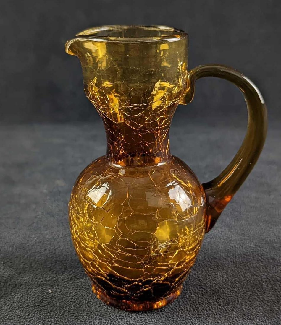 Vintage Amber Crackle Glass Small Pitcher Vase: Vintage Amber Crackle Glass Small Pitcher Or Vase. Its maker is unknown. Is approx 4" x 3" x 5 1/4" and it weighs 0.51lb. The small pitcher is in a good, vintage condition with no chips or cracks. Ple