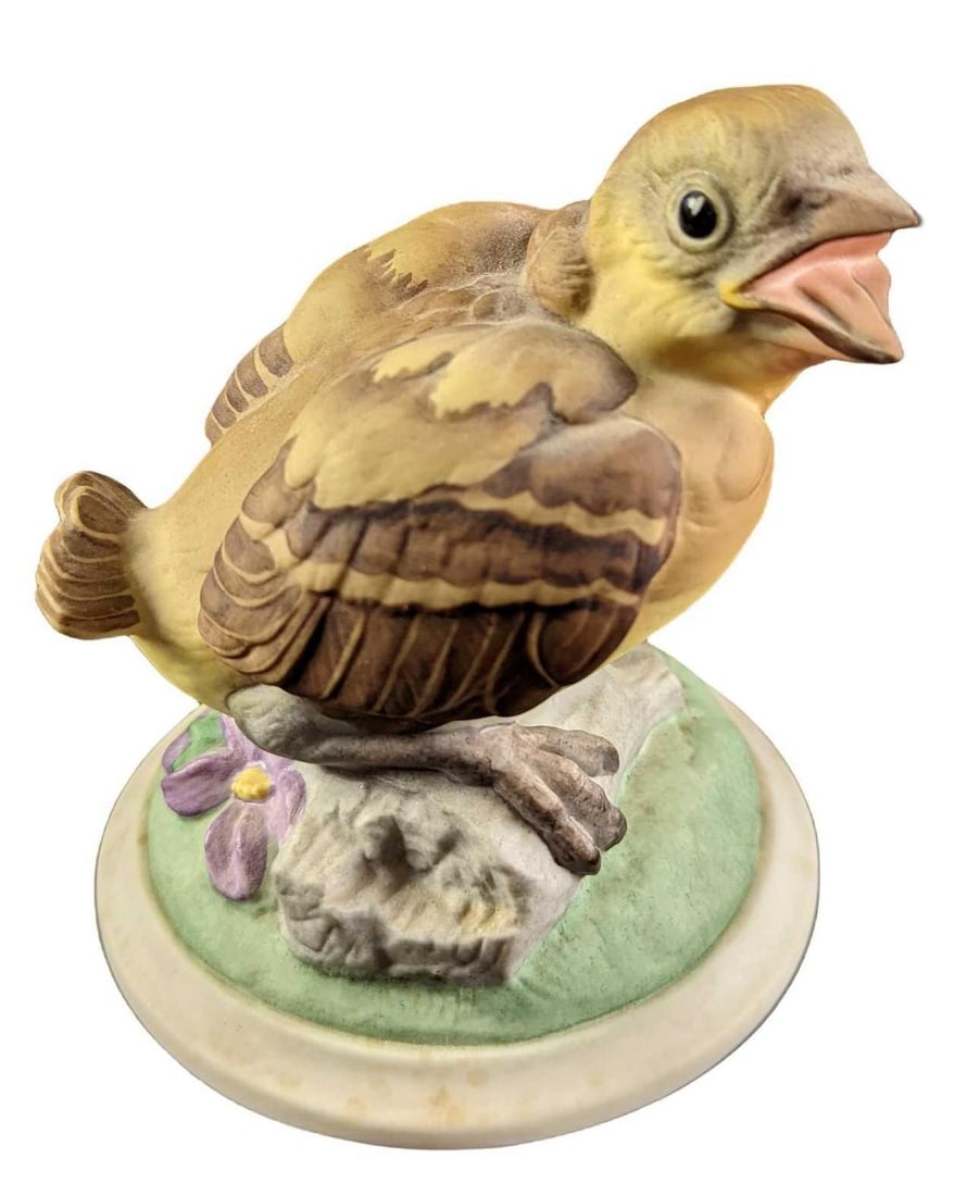 Boehm Birds Baby Goldfinch Porcelain Figurine: A baby Goldfinch tries out a new song. By Boehm. Is approx 3 3/4" x 3 3/4" x 4 1/2" and it weighs 0.50lb. The hand painted figure is in a good, used condition with some light wear, markings near the