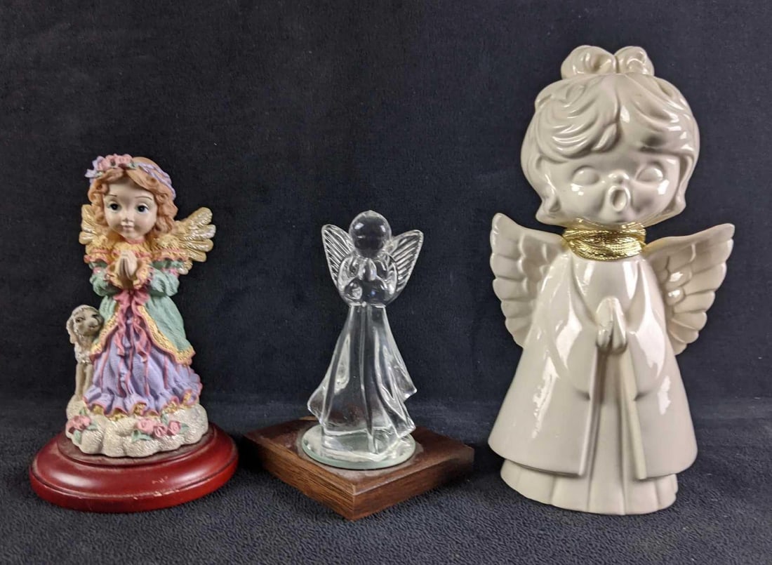 Lot of Three Angel Figures: Lot of Three Angel Figures This lot has three assorted angel figures. (1) White ceramic Angel small chip on hand 7"x4" (1) Small Glass Angle 5"x 3" (1) Resin Colorful Angle 5 1/2"x