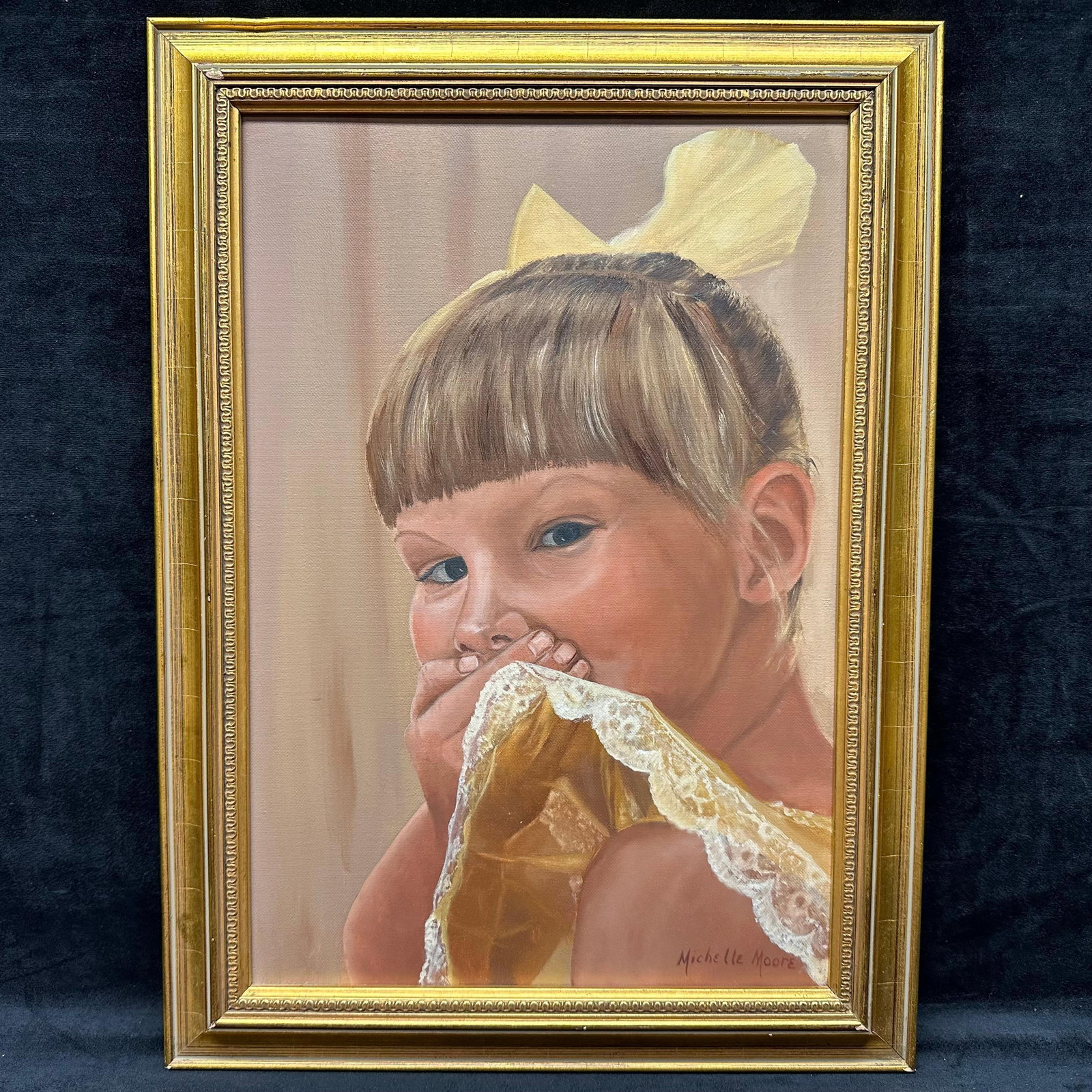 Framed Portrait Painting of Child Signed Michelle Moore: Original oil on canvas portrait painting depicting a young girl with a yellow bow and lace dress, holding fabric near her face. Signed by the artist in the lower right, Michelle Moore. Presented in a 