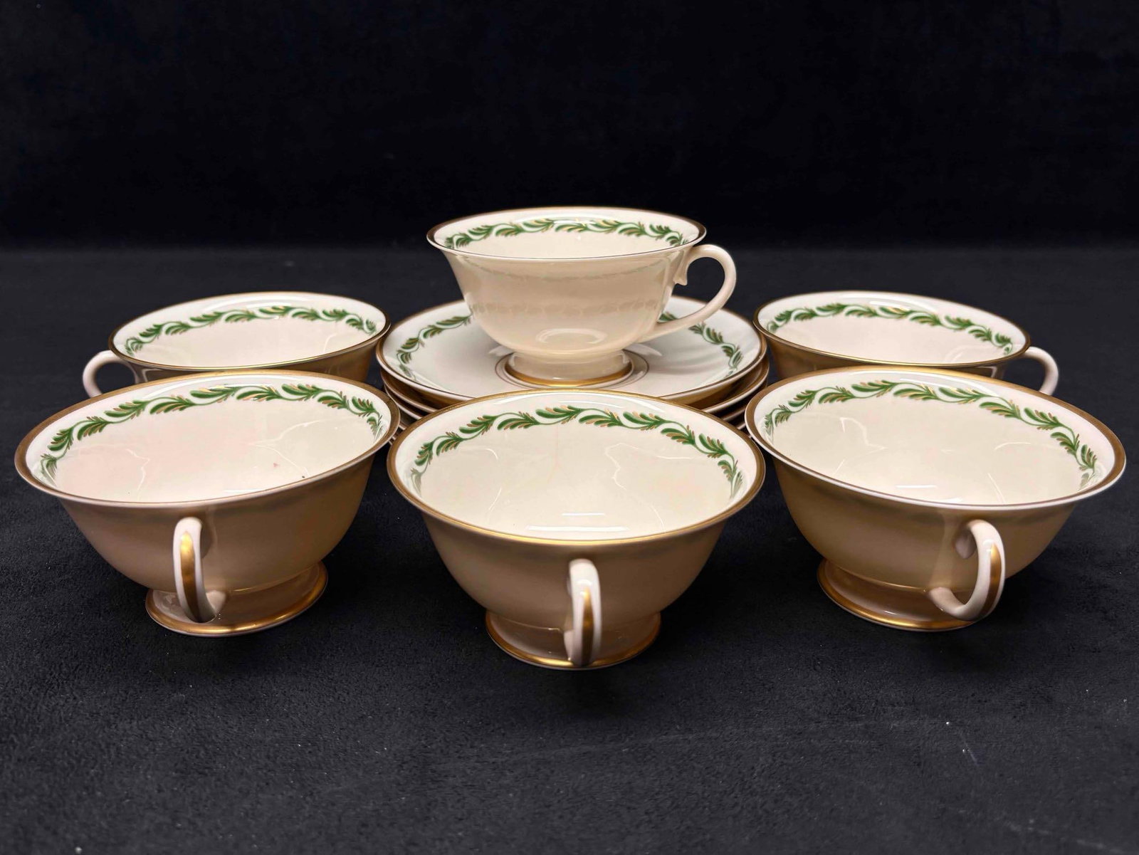 12pc Vintage Franciscan Arcadia Green Plumes Footed Teacup and Saucers: Adorned with green plumes and gold accents, this china tea set is a part of the now discontinued Arcadia Green line by Franciscan. Producing during the early 1940s to early 1960s, this lot is in good 