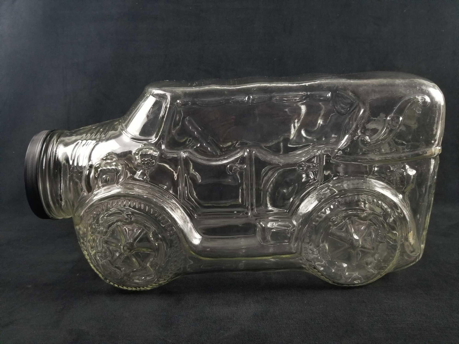 Large Clear Glass Cookie Jar In Shape Of Antique Car: Large clear glass jar in shape of antique car that can hold cookies, bubble gum, money and so much more possibilities! This jar is unique and will look great in a study or kitchen counter top. Comes w