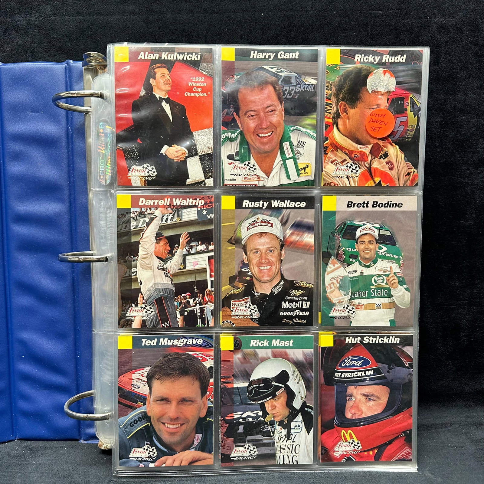 90s Finish Line NASCAR Racing Card Collection Blue Binder Sport Trading Cards Over 300: Large collection of 1990's Finish Line NASCAR racing cards housed in a “Race Card Album” blue binder. Includes drivers, crew members, and car cards such as Richard Petty, Dale Jarrett,