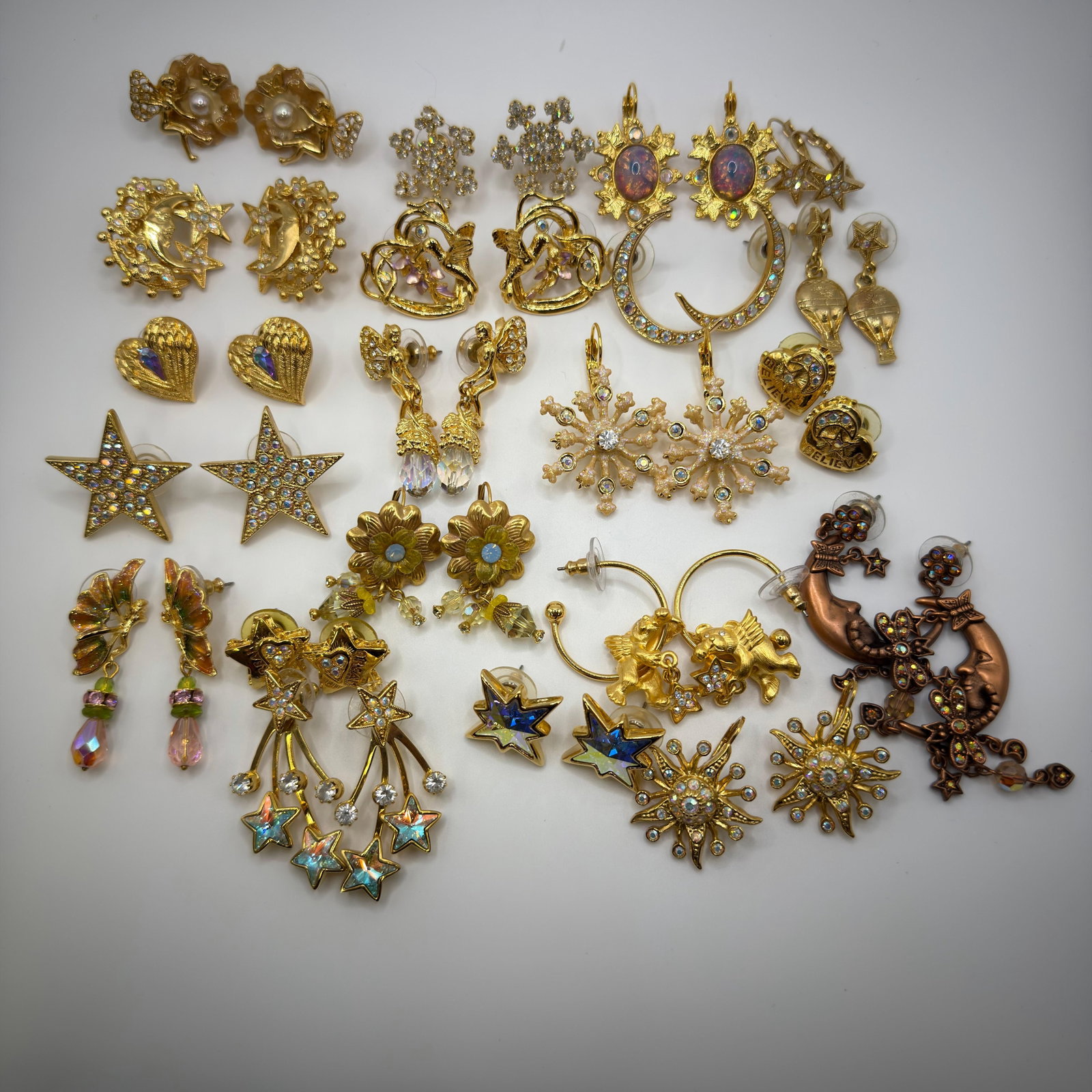 Large Kirks Folly Signed Celestial Fantasy Fairy Star Moon Motif Earrings Group 21 Pairs: Large collection of signed Kirks Folly gold-tone fantasy earrings featuring celestial and whimsical motifs. Includes moon and stars, snowflakes, suns, flowers, cherubs, hot air balloons, angels, butte