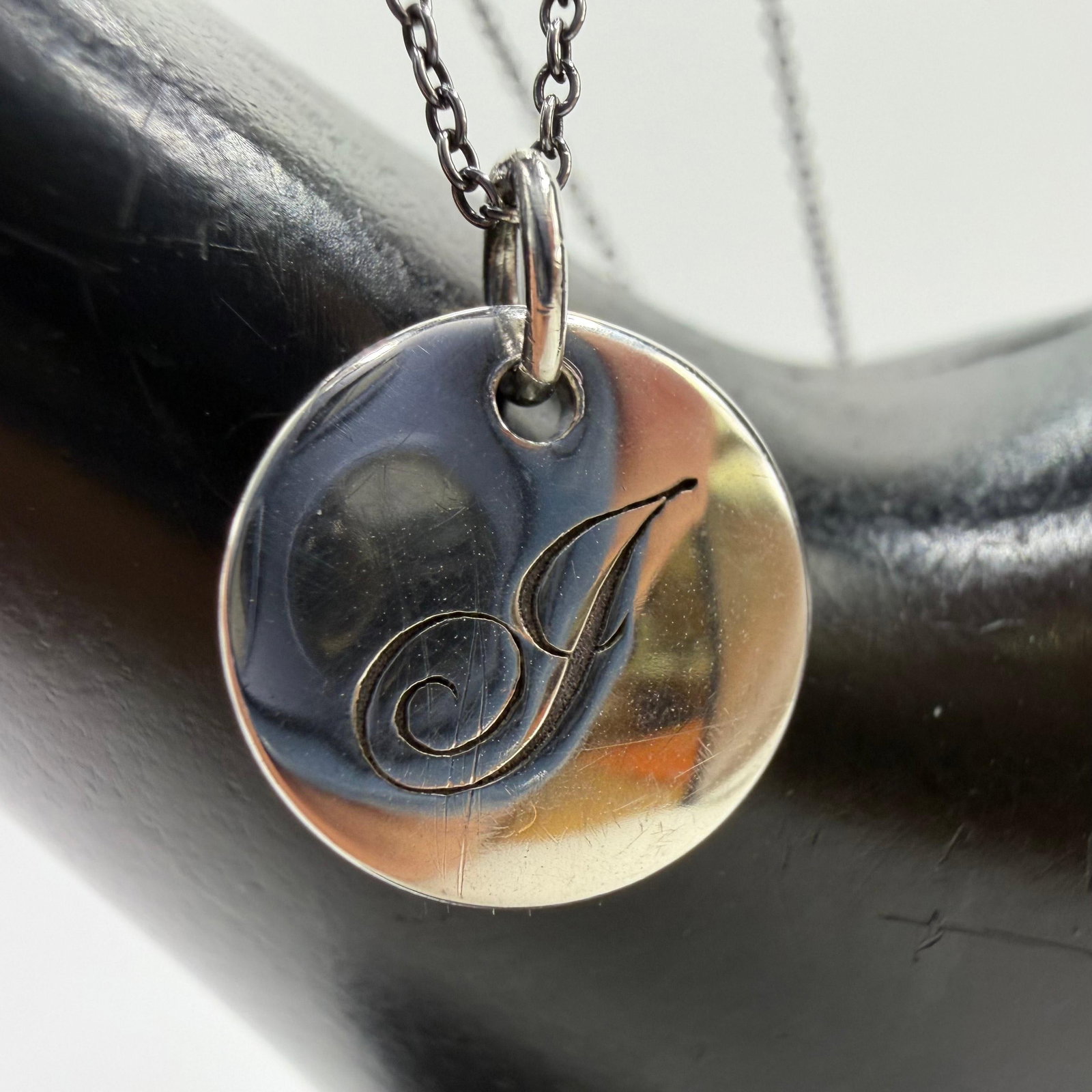 Tiffany and Co. Letter J Initial Alphabet Disc Charm Pendant Necklace Sterling Silver AG925: This item is in good pre-owned condition, previously used/displayed, with noticeable light wear and surface scratches. Please reference all photos for full details. This piece of jewelry has been care