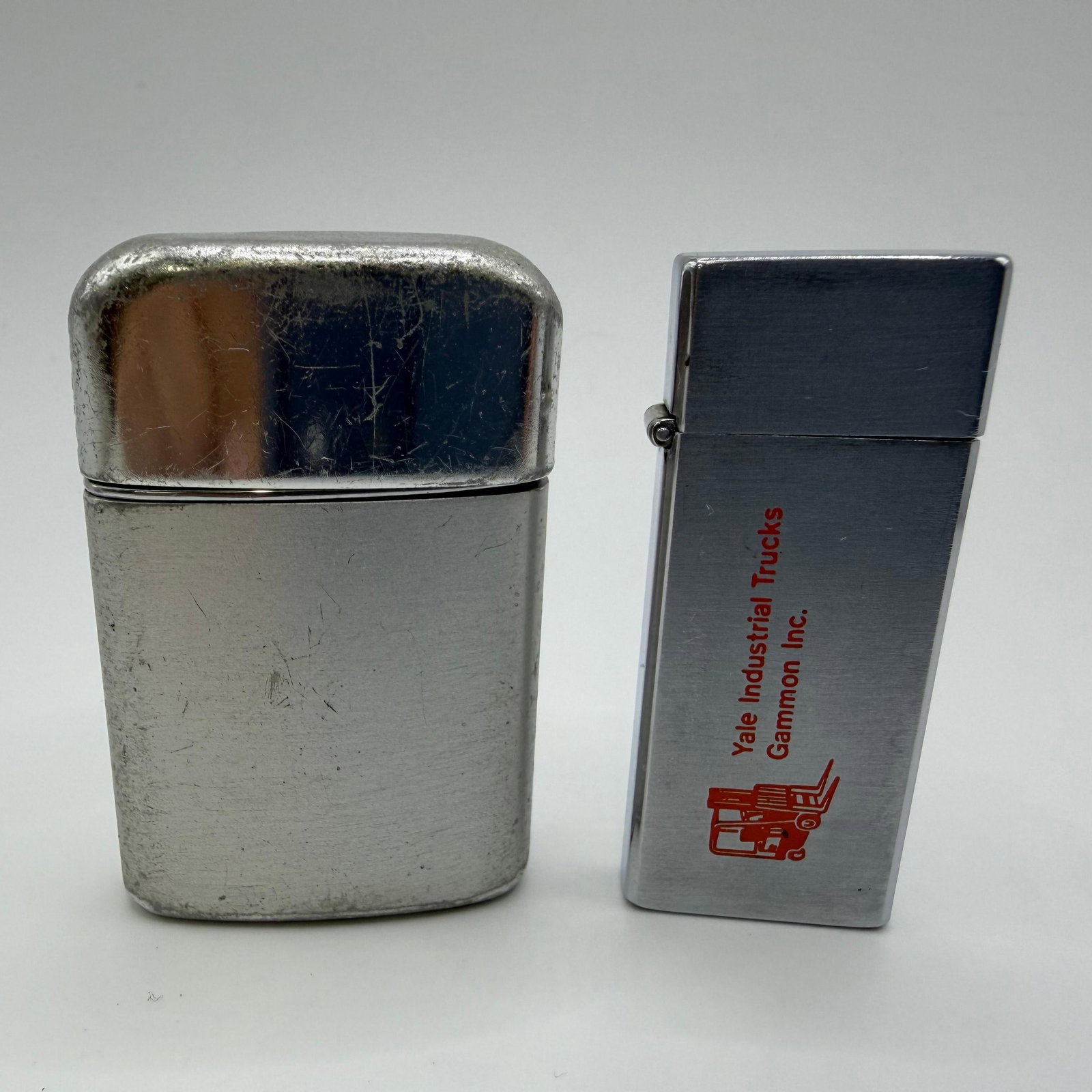Ronson Typhoon and Barlow B17 Tallboy Pocket Lighters: Pair of vintage refillable pocket lighters including a Ronson Typhoon marked "British Empire Made" and "Hong Kong" on the base, along with a Barlow B17 Tallboy lighter made in Japan fe