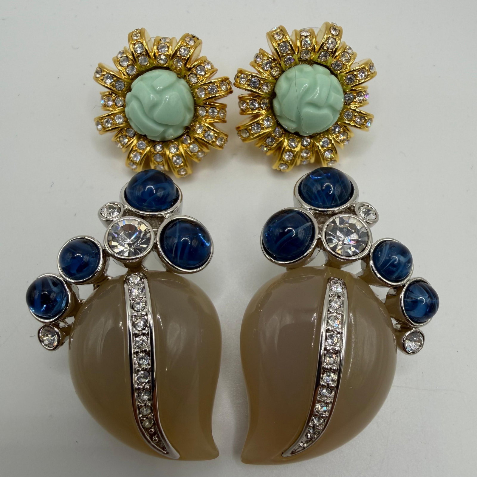 Kenneth Jay Lane Treasures of the Duchess Clip-On KJL Earrings: Collection of two pairs of Kenneth Jay Lane "Treasures of the Duchess" clip-on and post earrings. Includes one pair of gold-tone earrings with simulated turquoise carved cabochons accented by 