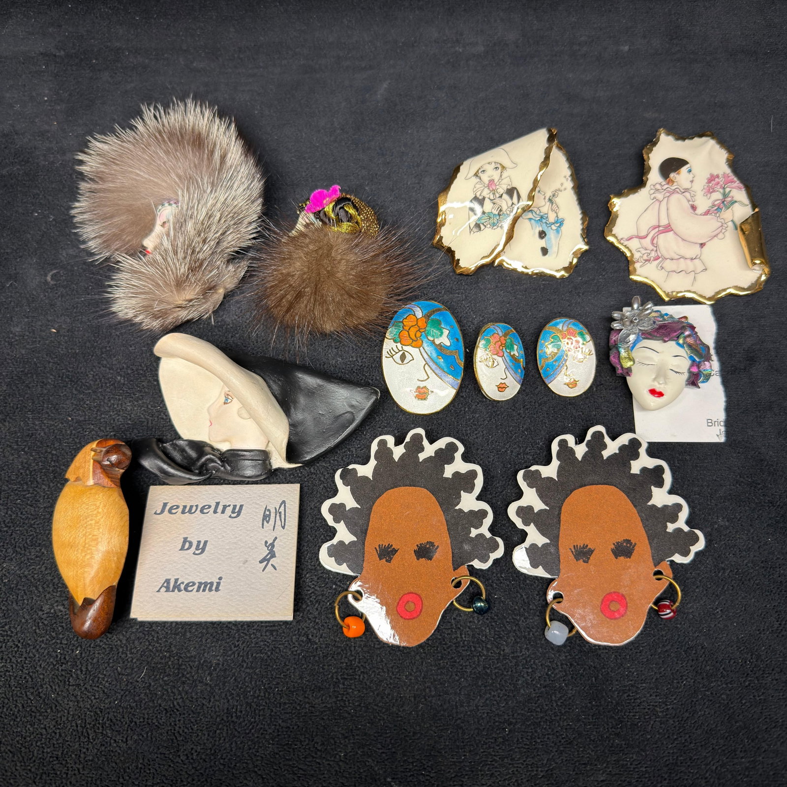 Artisan Figural and Fashion Brooch Collection Including Akemi Mink Fur Enamel and Wood Jewelry: Collection of vintage artisan costume jewelry brooches, earrings, and pins featuring a variety of figural and fashion designs. Includes Jewelry by Akemi lady profile brooch, carved wooden bird brooch,
