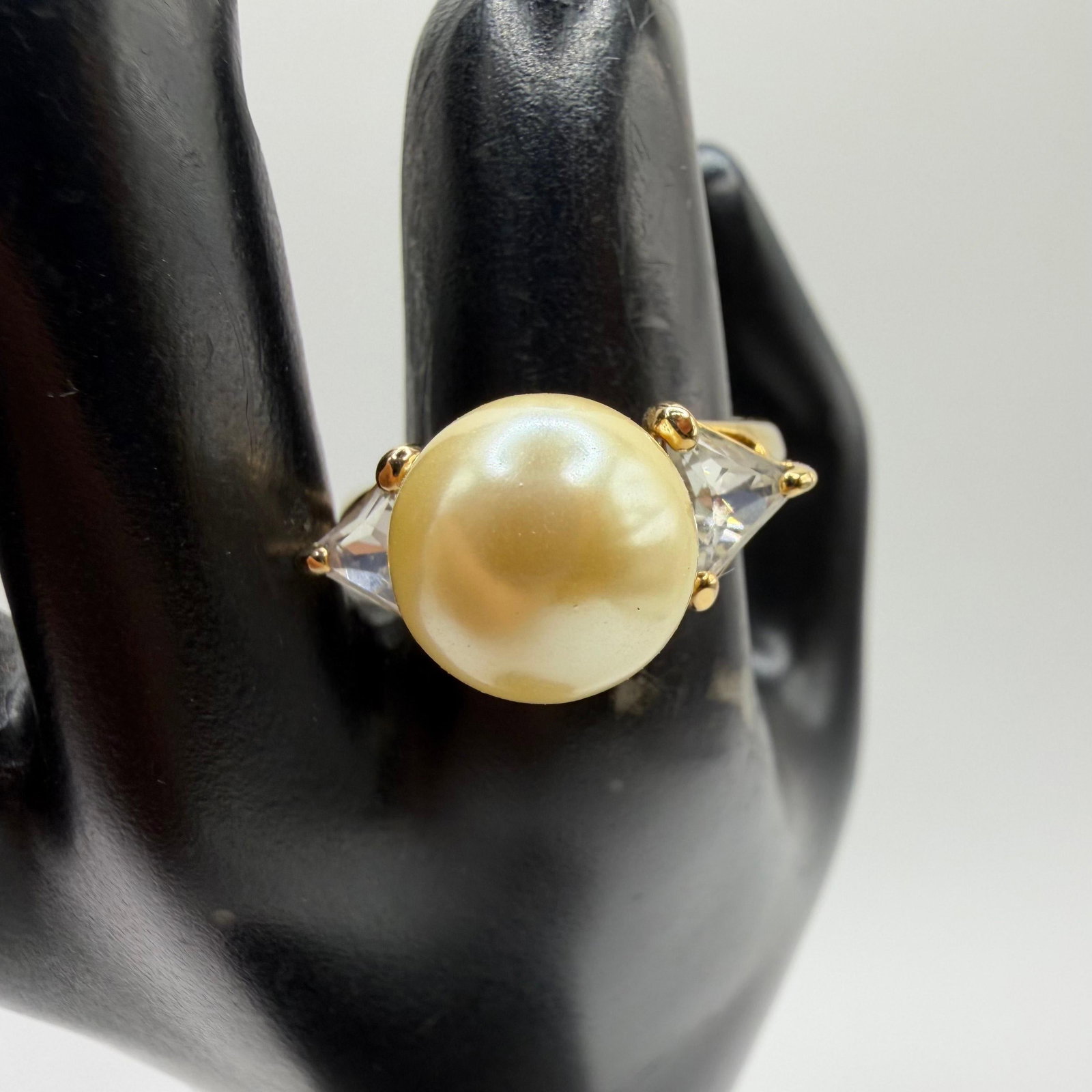 Nolan Miller Ring Faux Pearl Rhinestone Baguettes Uptown Ring Sz 10: This is a Nolan Miller uptown faux pearl ring featuring a large faux pearl encircled by clear baguette-style rhinestones in a gold-toned metal ring. Includes Nolan Miller jewelry box. This item is in