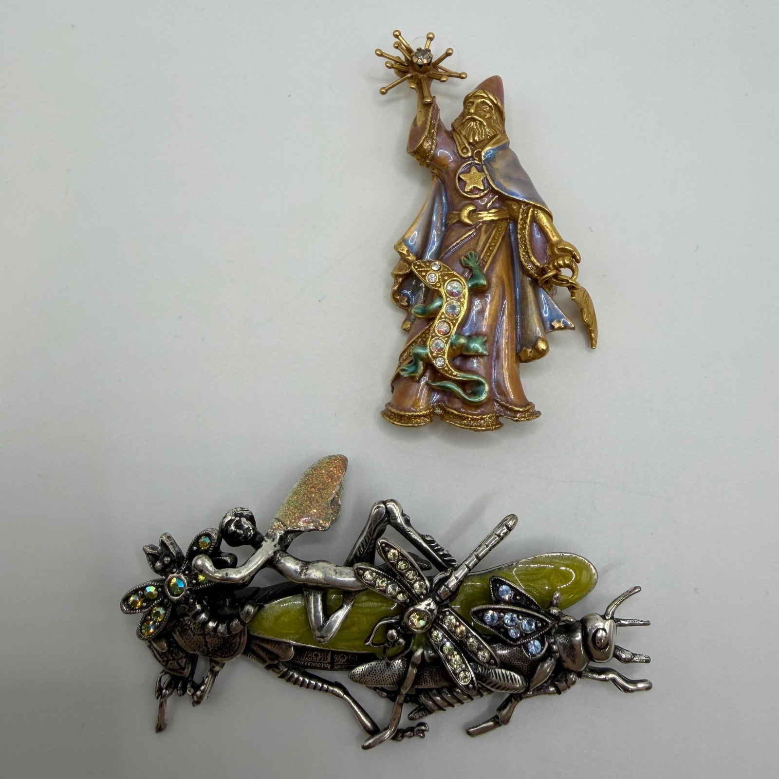 Kirks Folly Wizard and Fairy Grasshopper Enamel Crystal Brooch Fantasy Set HG3: Collection of two signed Kirks Folly fantasy-themed brooches. Includes a whimsical enamel wizard holding a crystal-tipped magic staff with celestial details, and a large fairy riding a grasshopper