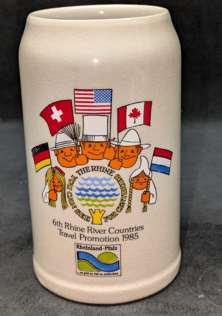 6th Rhine River Countries Travel Promotion 1985 Stein: 6th Rhine River Countries Travel Promotion 1985 Stein. 1 Liter. This ceramic stein is approx 6 1/2" x 4 1/2" x 7 3/4" and it weighs 2.48 lbs. The stein is covered with crazing, both inside and